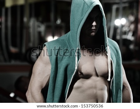 Athletic strong bodybuilder, execute exercise training in sport gym hall