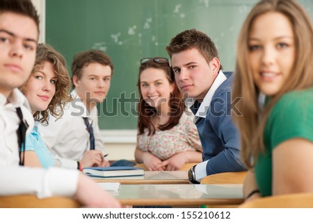 A group of nicely dressed students sitting in a classroom