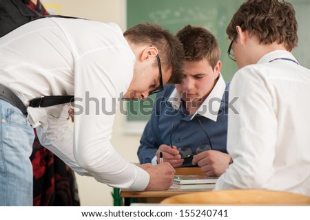 Three young students working together in a classroom