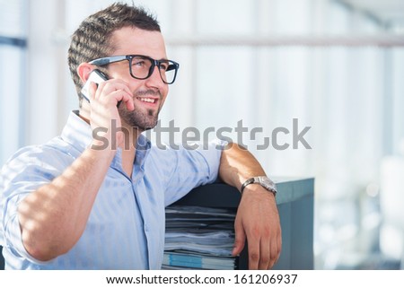 Handsome businessman with cellphone smiling