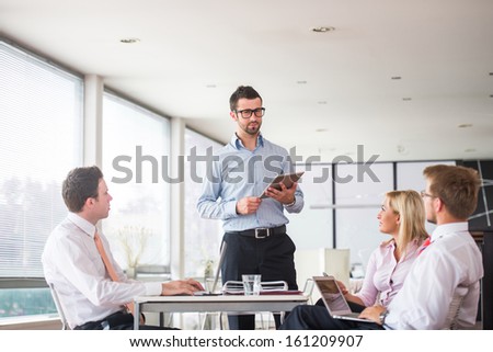 Team of four people meeting in office