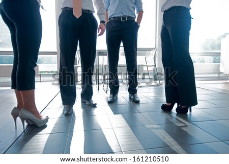 Low section of a team of managers standing on a modern office floor