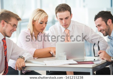 Corporate team of four meeting in office