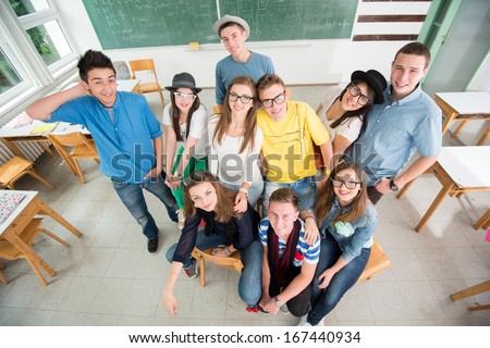 Group of happy students in classroom from above
