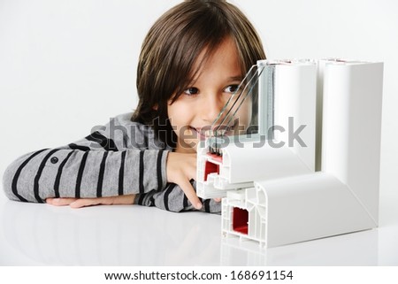 Kid holding plastic window profile