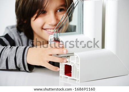 Kid holding plastic window profile