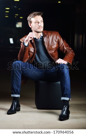 Fashionable young man with leather clothes on