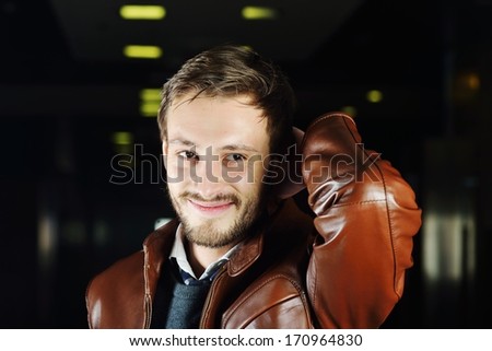 Fashionable young man with leather clothes on