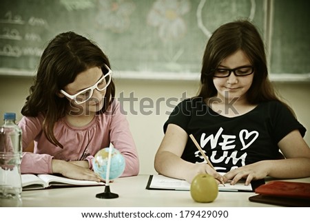 Cheerful kids at school room having education activity