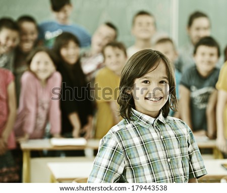 Cheerful group of kids at school room having education activity