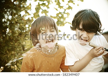 Retro image of cheerful kids drinking water from the pipe