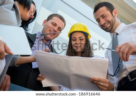 Smiling team of construction engineers working as a team