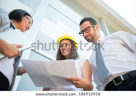 Engineers reviewing construction plans together