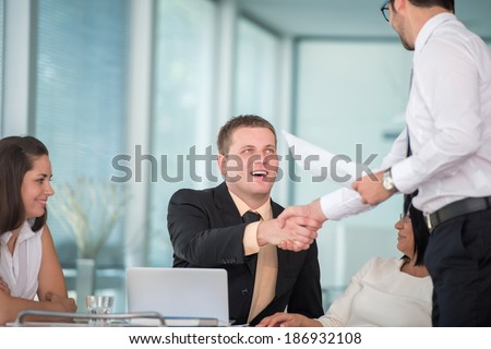 Two business men shaking hands to seal an agreement in office
