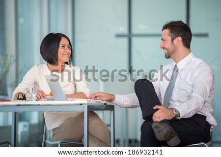 Business man flirting to a female colleague in office