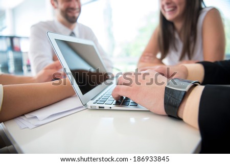 Business man working with laptop in office with colleagues