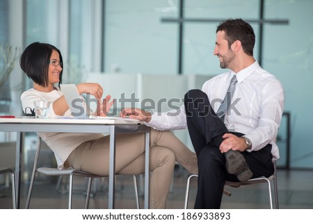 Handsome couple flirting in office environment