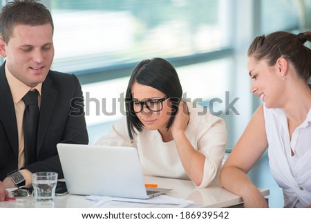 Business woman with glasses working with team