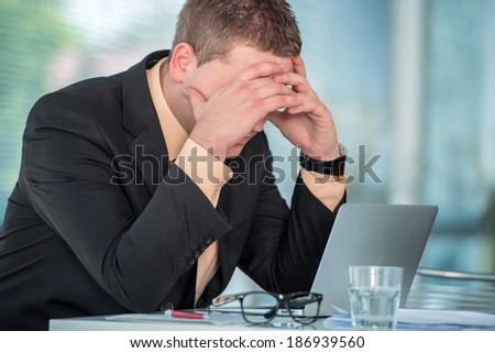Worried businessman sitting in office