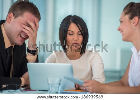 Laughing business people working in modern office