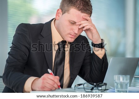 Worried man working in modern office