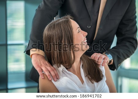 Business woman having fun with colleague at workplace