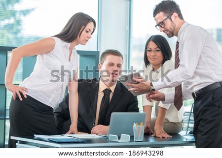 Group of young people at work in office