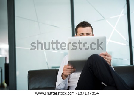 Business man with laptop computer working in modern interior