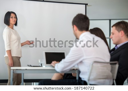 Business woman delivering a presentation during company work meeting