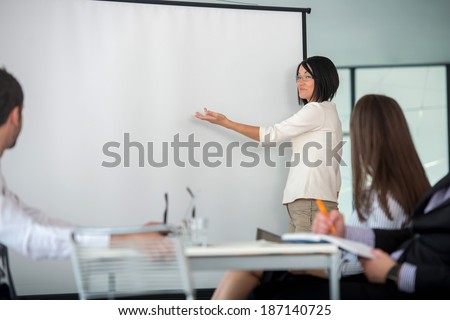 Business woman delivering presentation during work meeting in office