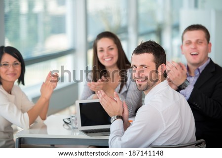 Happy team of business people posing in modern office environment