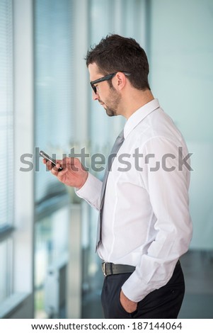 Successful manager using mobile phone in office