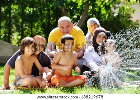 Three generations family having fun happy time with water by the summer time