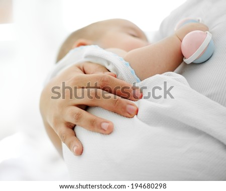 Baby having mom\'s care