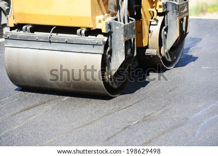 Men hard working on asphalting road