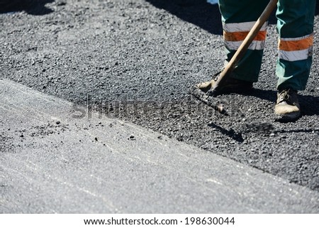 Men hard working on asphalting road