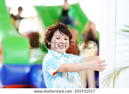 Children playing on colorful kindergarten playground