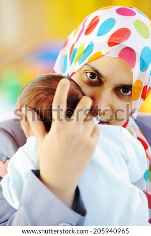 Muslim mom with newborn baby several days old enjoying new life