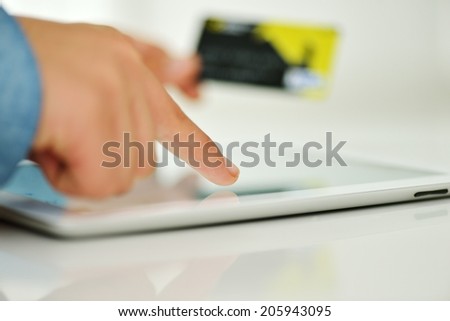Human hand on tablet pc and credit card for shopping online