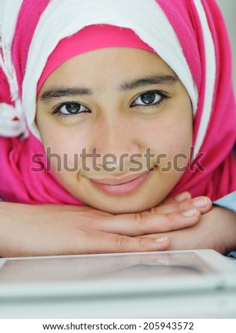 Portrait of beautiful Arabic Muslim girl using tablet