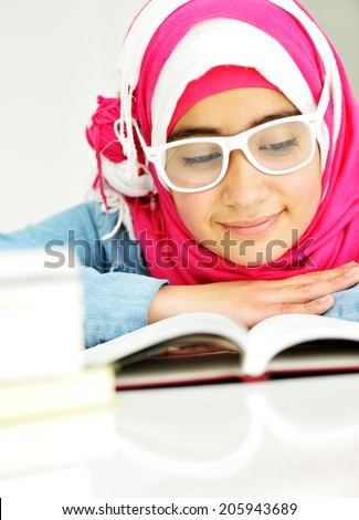 Beautiful Arabic Muslim girl reading on college