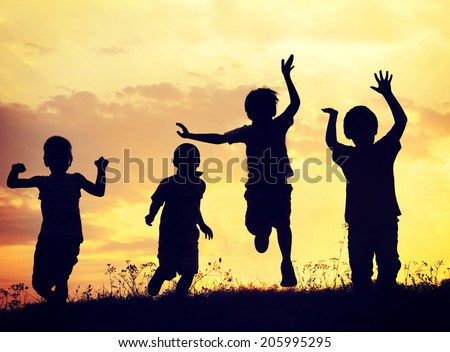 Children playing on summer sunset meadow