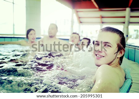 Group of young peoples enjoying on pool and jacuzzi