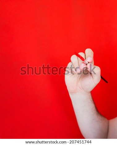 Hand painting red wall