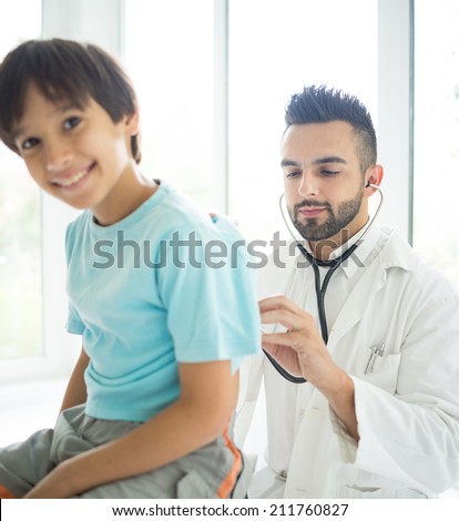Doctor examining a school boy at hospital