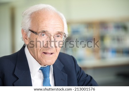 Portrait of an senior god looking business man with suit and old gray hair