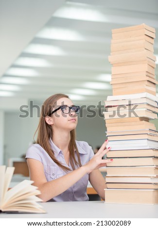 College female student on university campus with pile of books