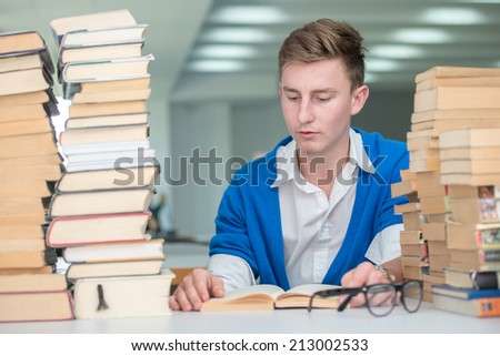 College student on university campus desk reading for research
