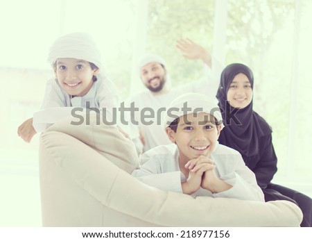 Middle eastern family at home on couch