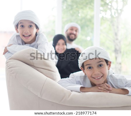 Middle eastern family at home on couch